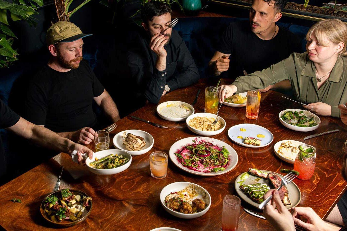 Friends sit around a table for dinner at 5th St Christchurch